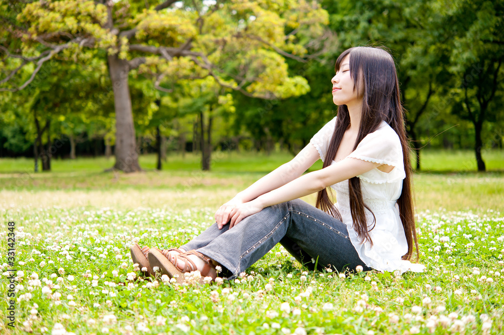 beautiful asian woman relaxing in the park