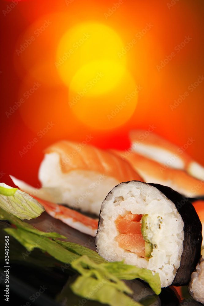 Delicious sushi on shiny blur background