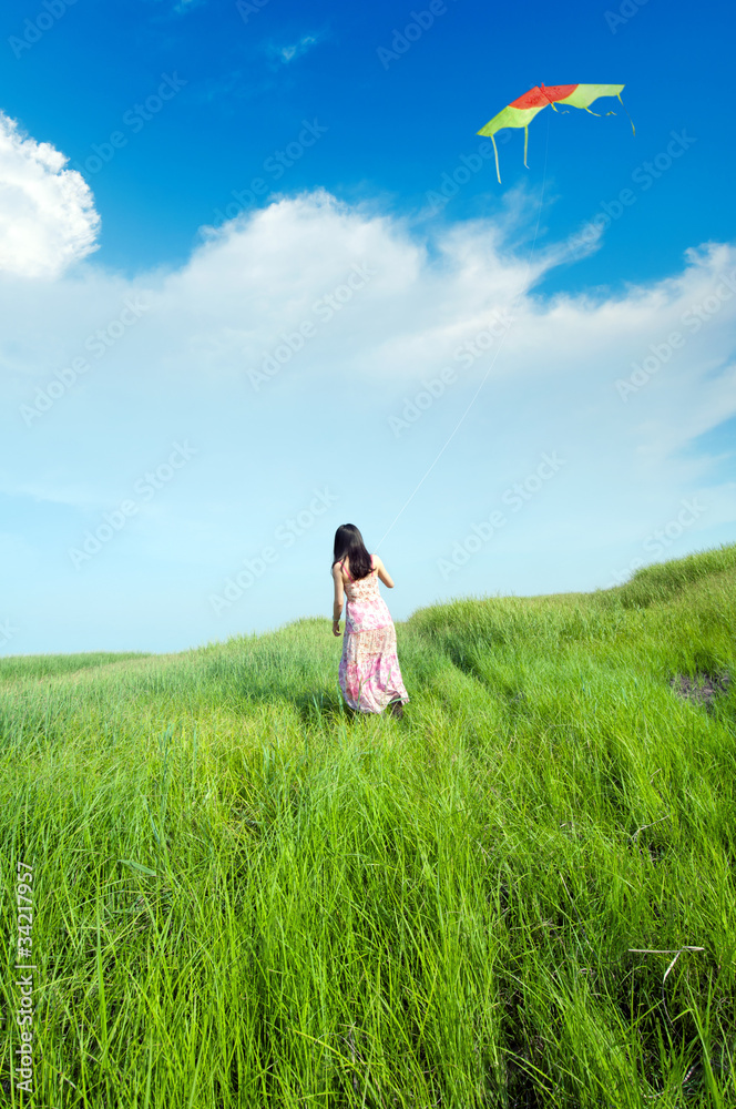 Girl flying a kite on the prairie