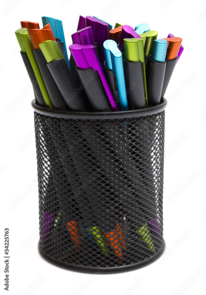 ballpoint pens in pencil holders on white