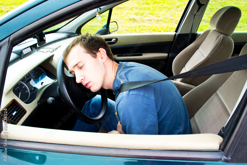 man sleeps in a car