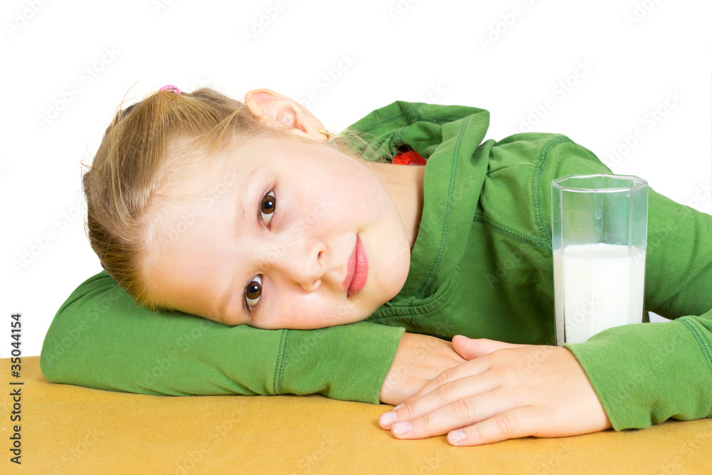 Cute little girl with a glass of milk, isolated over white