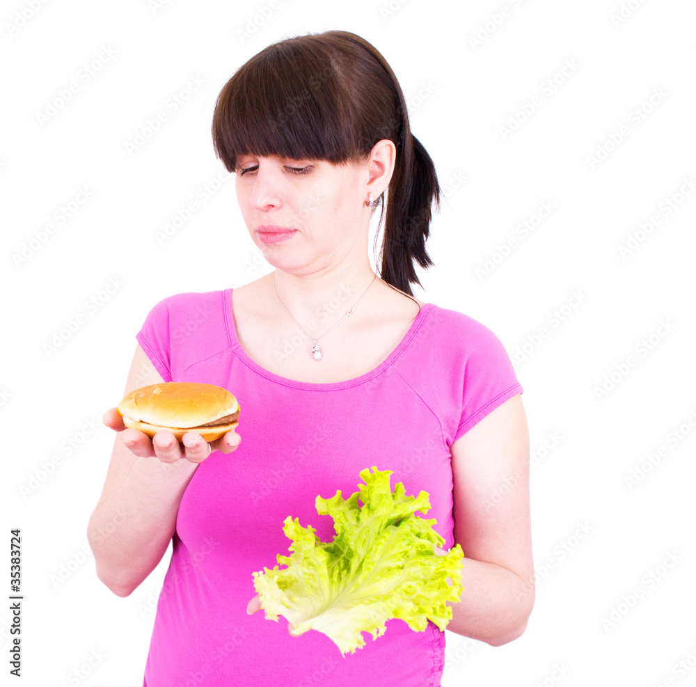 woman with lettuce and hamburger on the white background