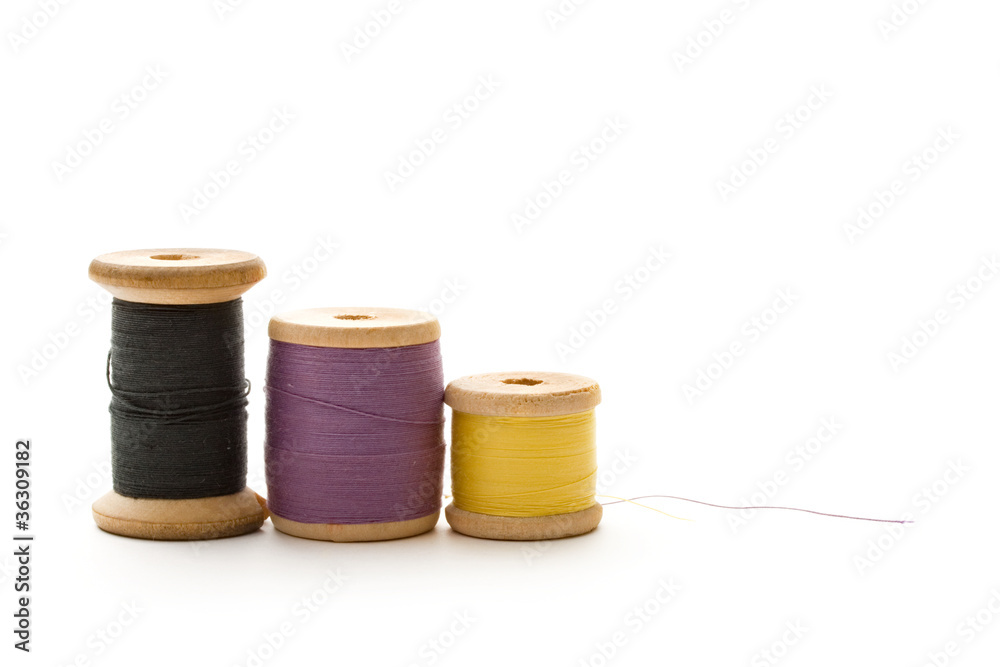 Thread bobbins on the white background