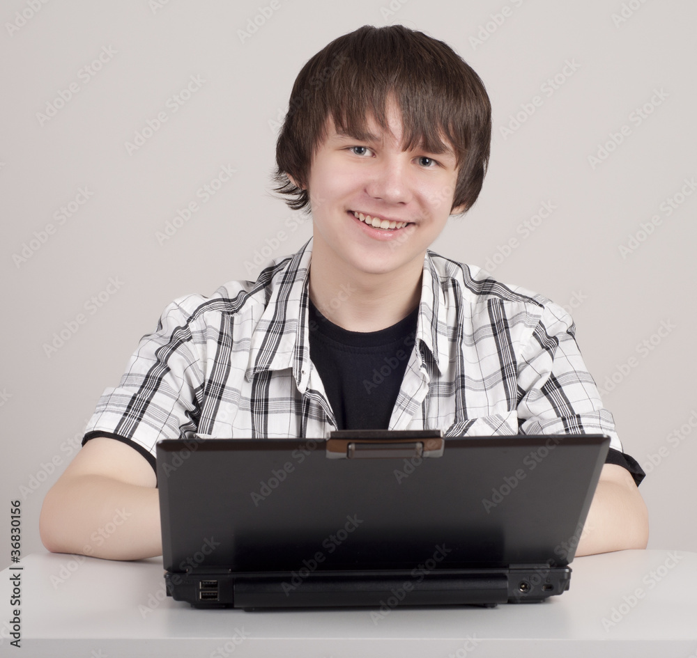 student sits for a portable computer