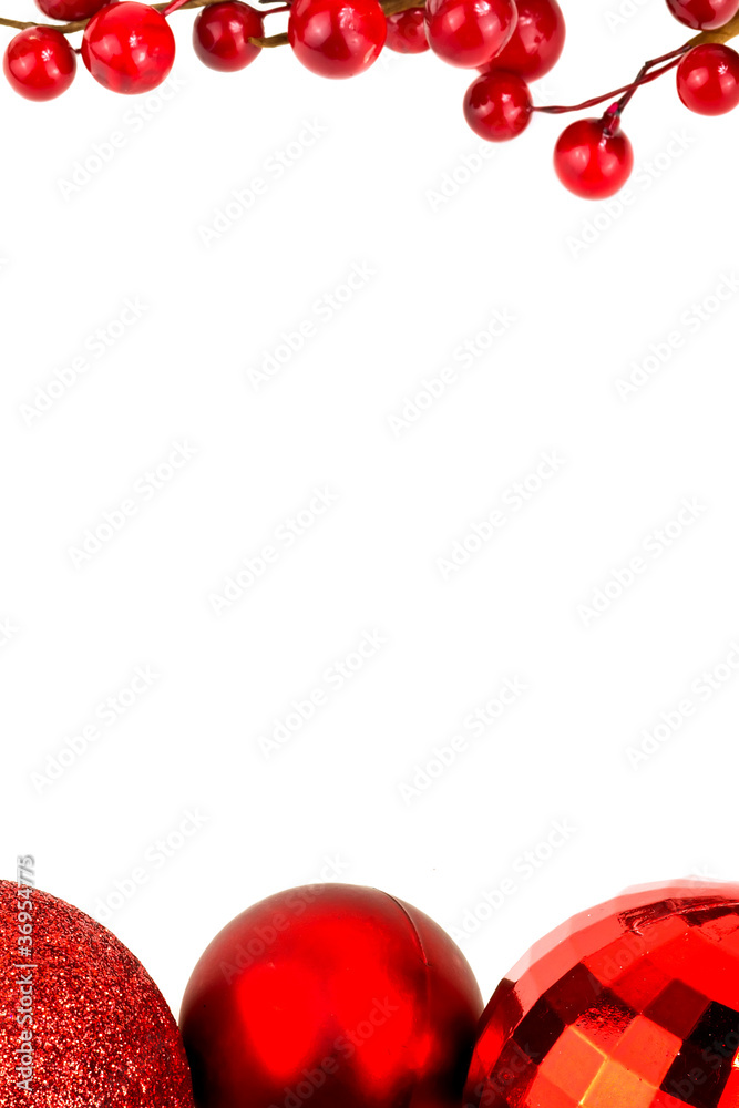 Chrismas baubles and red berries on white background