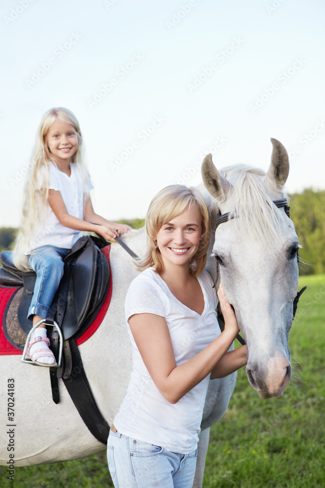 Mother and daughter with a horse