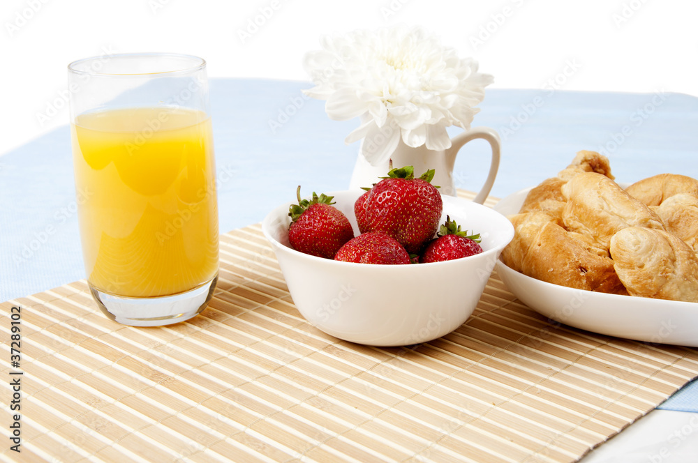 juice, croissants and Berries On a bamboo