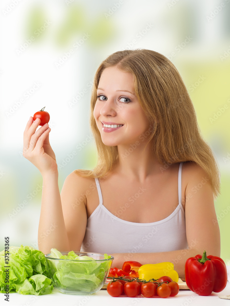 beautiful  girl with vegetables in the kitchen