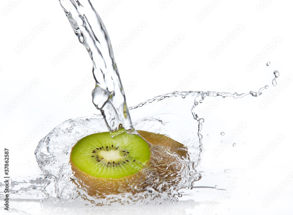 Fresh kiwi in water splash, isolated on white background