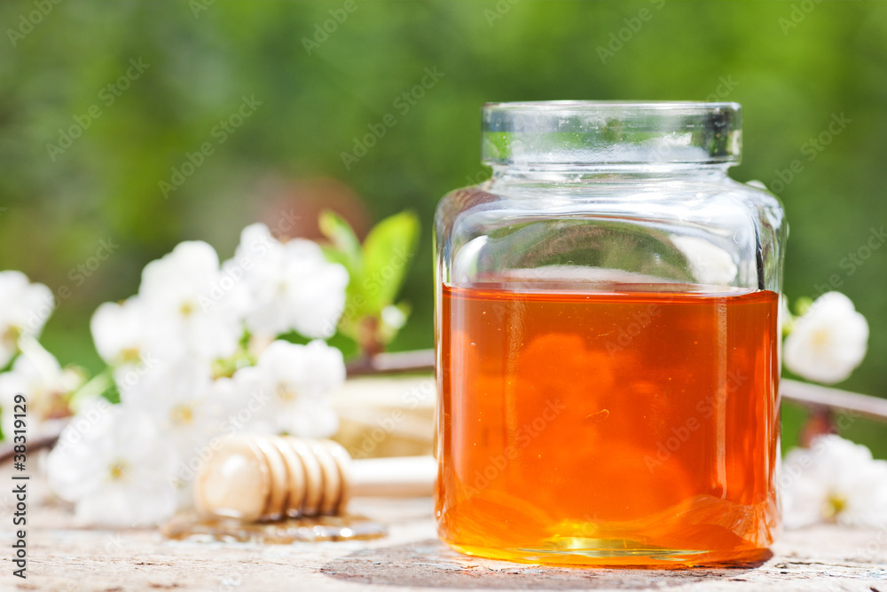 Flowery honey in glass jar