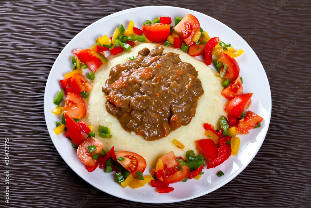 Beef goulash with potatoes and vegetables salad