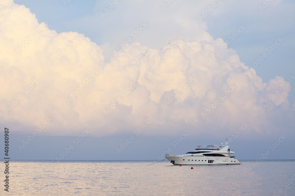 white yatch and plain sea blue sky white clouds