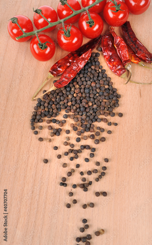 Tomatoes and peppers on wooden board