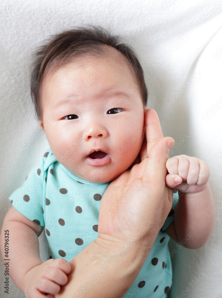 mother hand touch baby smile face