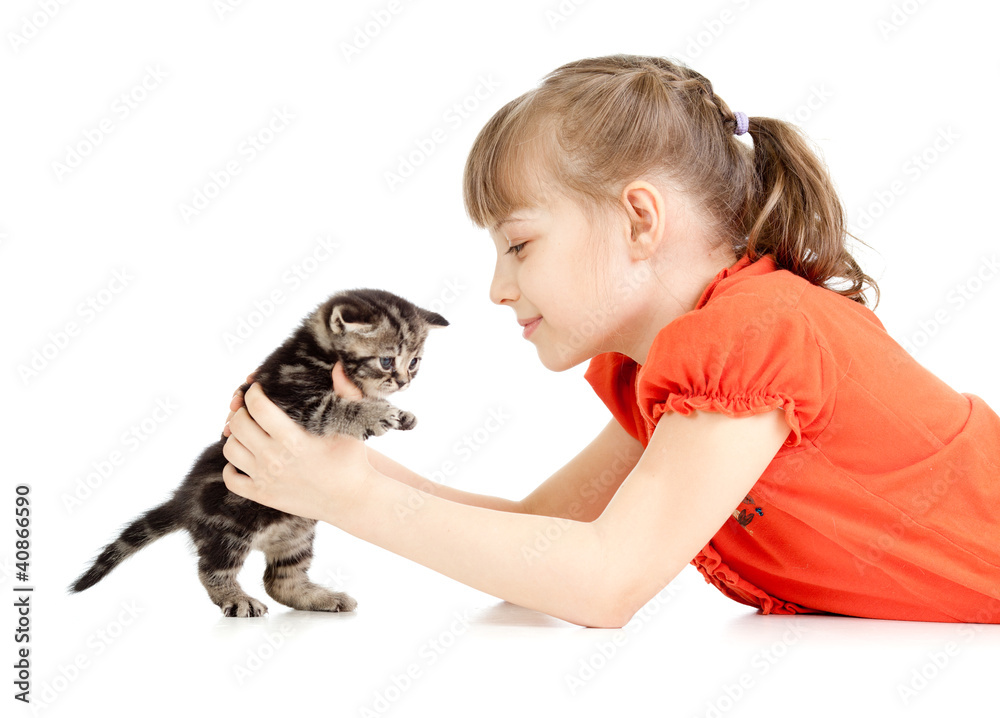 Girl lying with British kitten isolated on white