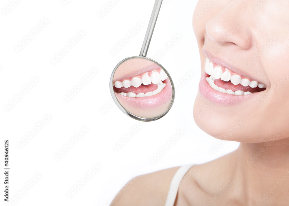 Healthy woman teeth and a dentist mouth mirror