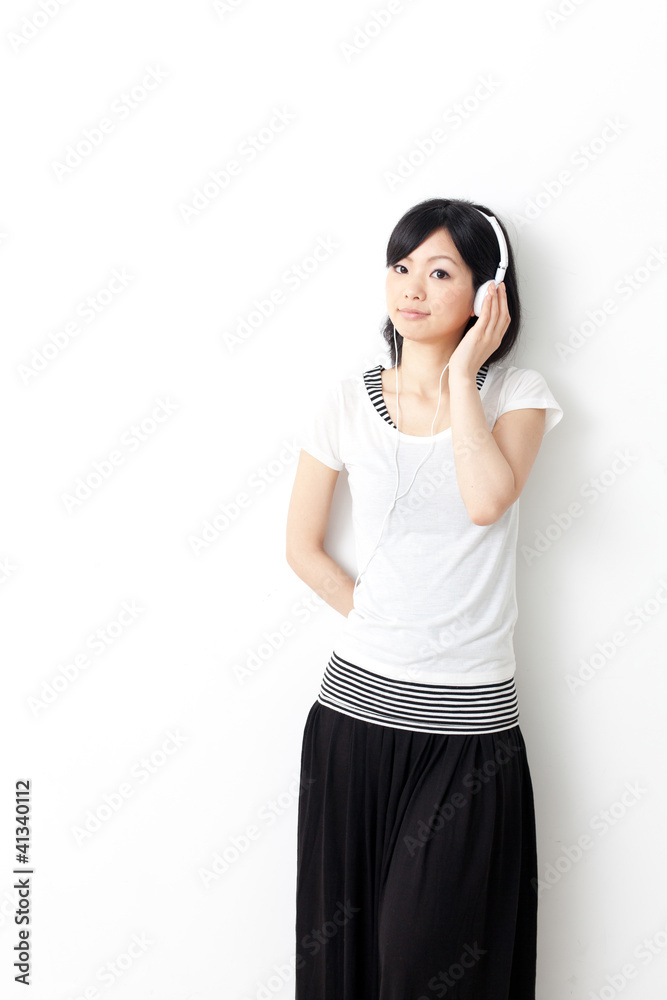 attractive asian woman listening music