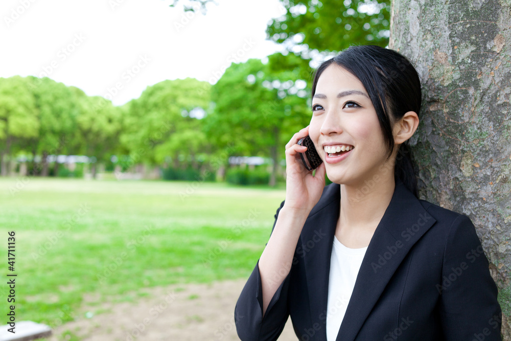 asian businesswoman talking in the park