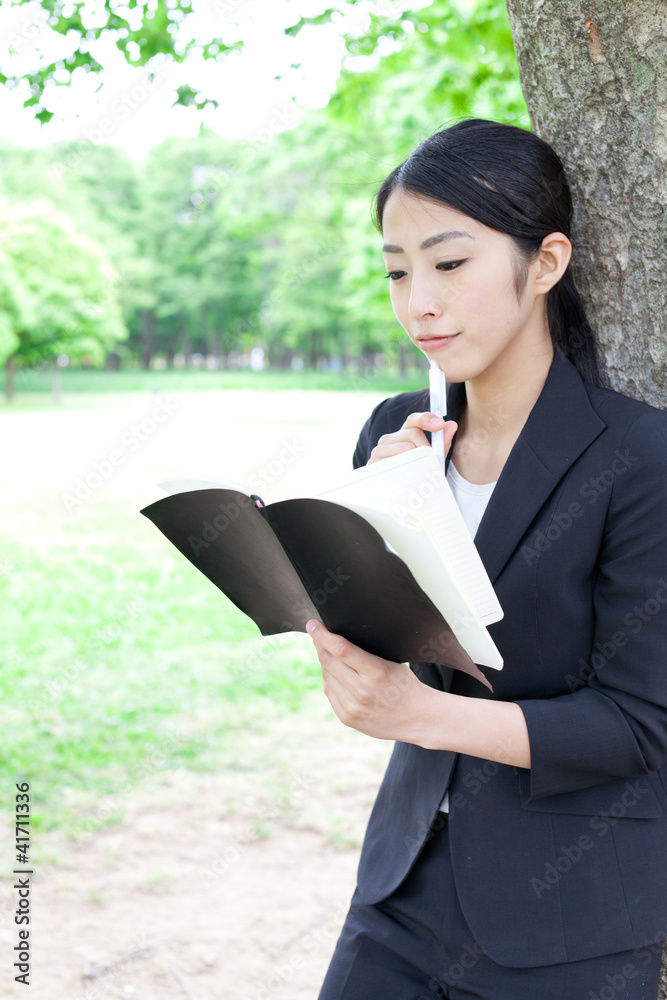 asian businesswoman working in the park