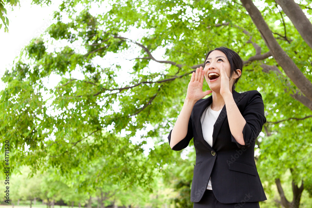 asian businesswoman cheering in the park