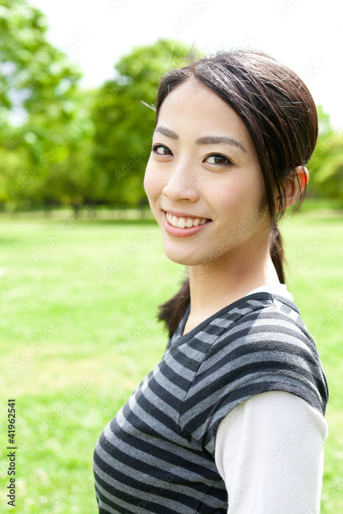 a portrait of young asian woman in the park