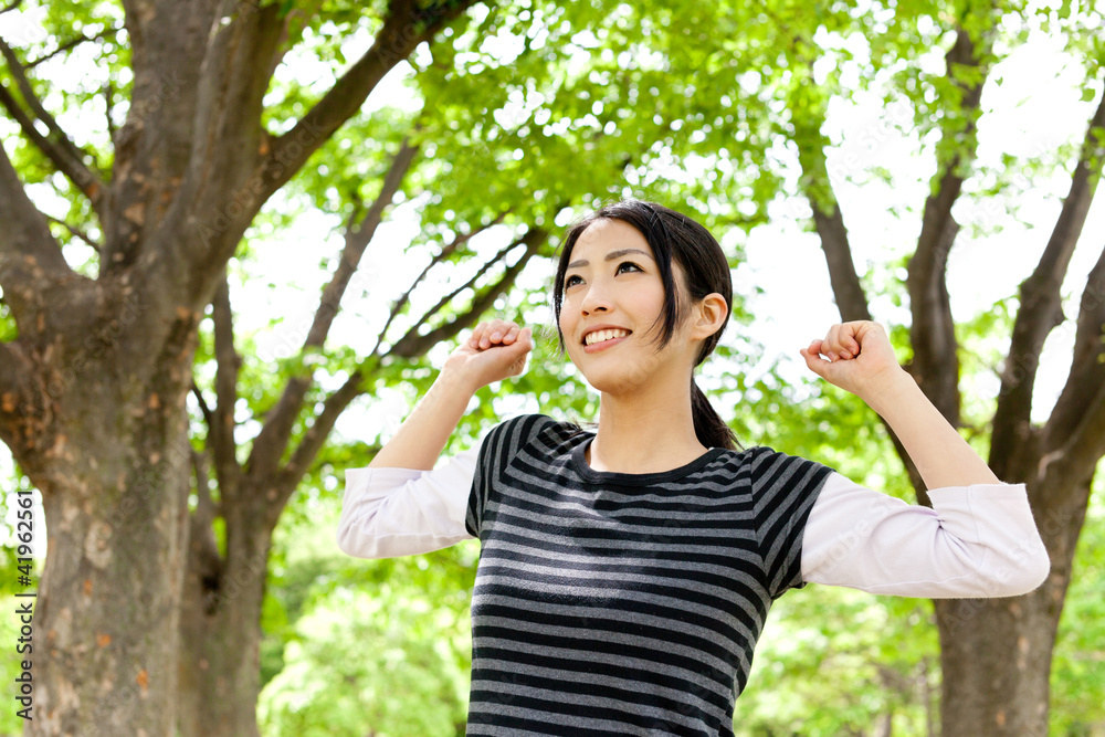 young asian woman relaxing in the forest