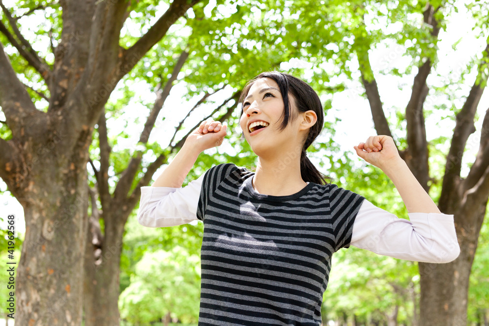 young asian woman relaxing in the forest