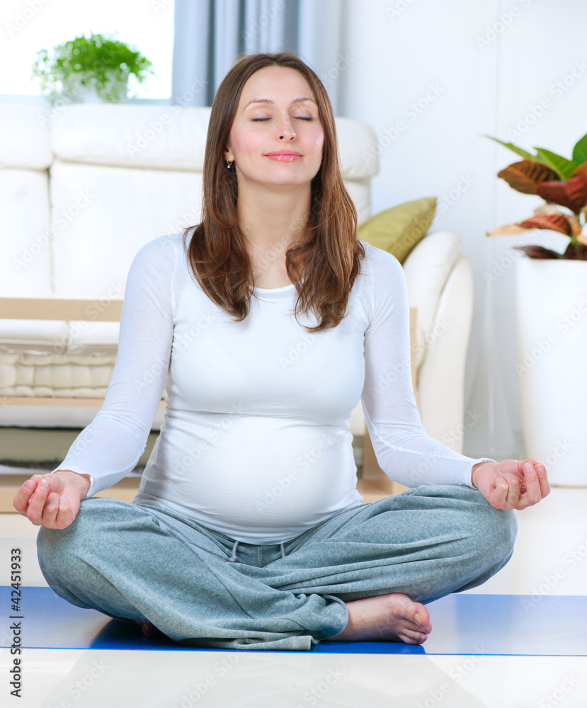 Beautiful Pregnant Woman Doing Yoga at Home