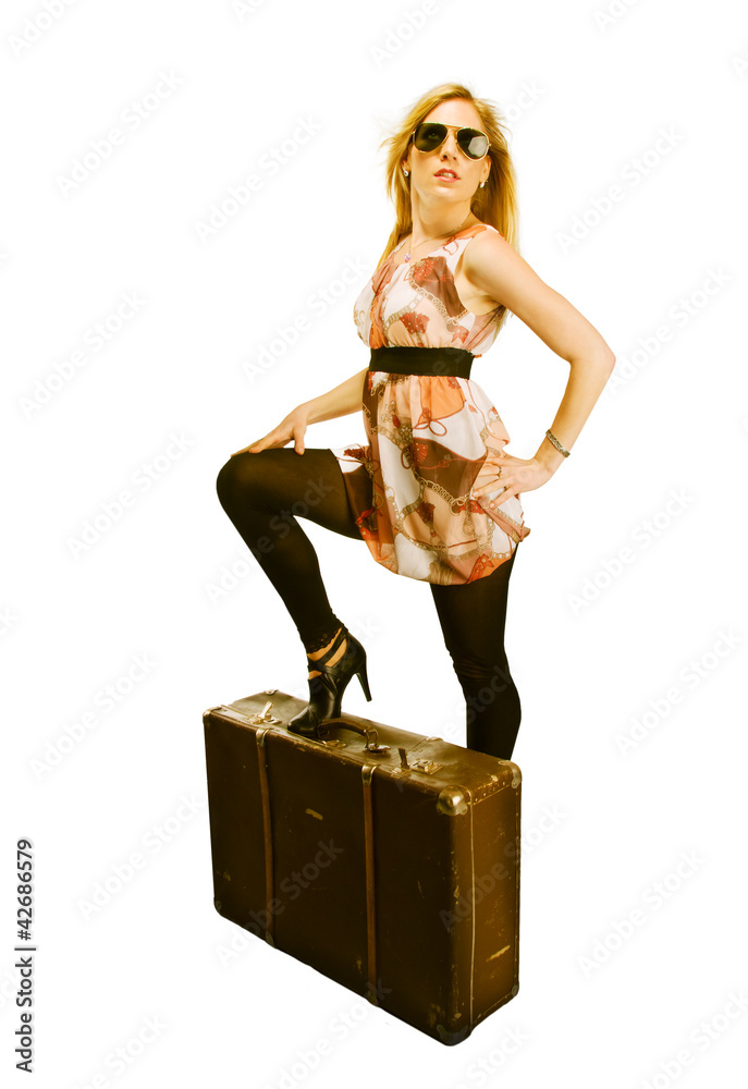 Beautiful blond woman with suitcase, dressed in retro style