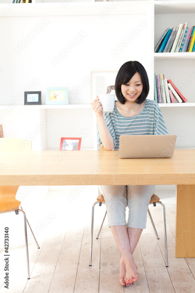 a young asian woman using laptop computer