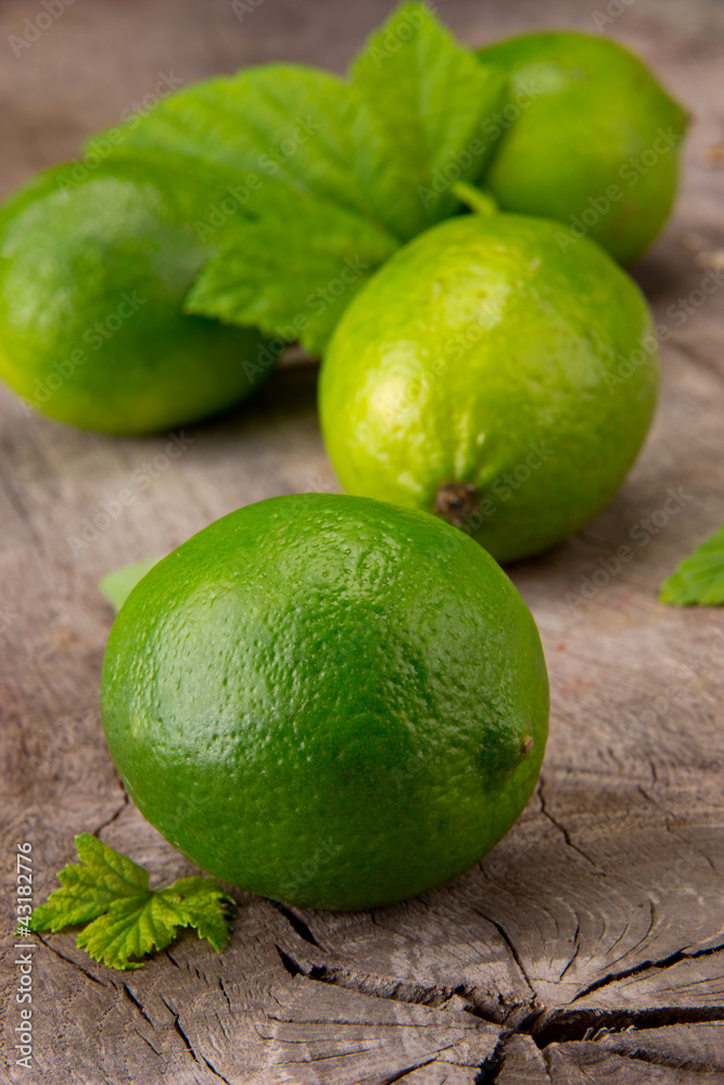 Fresh limes on wooden table