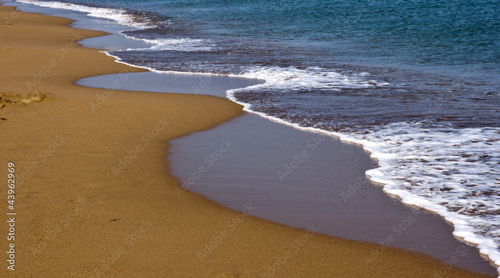 Beach with golden sand and blue waves