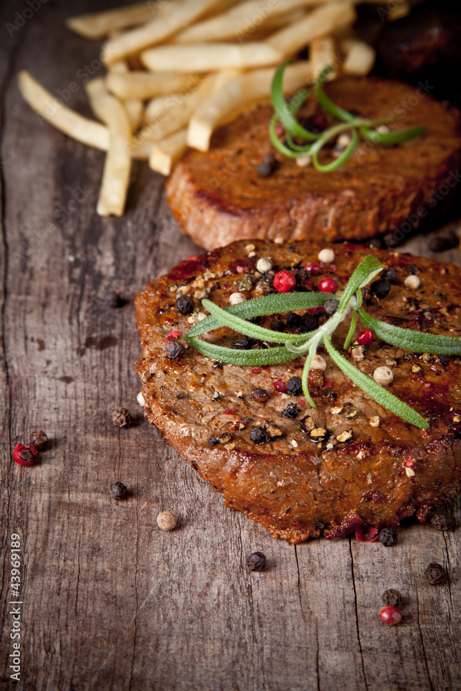 Delicious beef steaks on wooden table