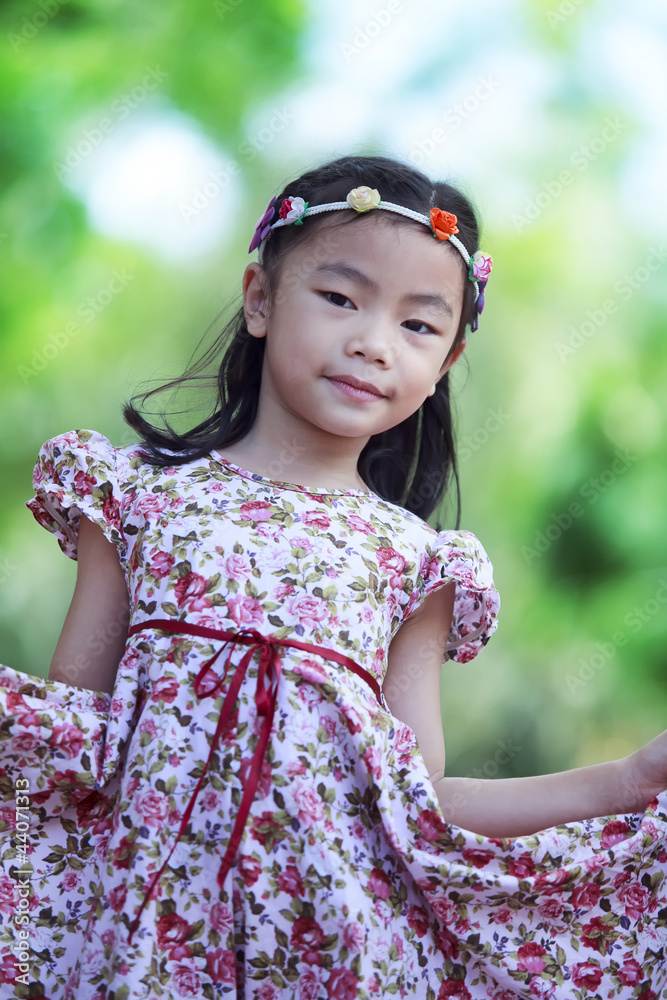 Beautiful child with sunflower in spring field