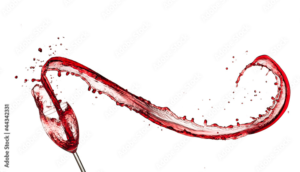 Red wine splashing out of glass, isolated on white background