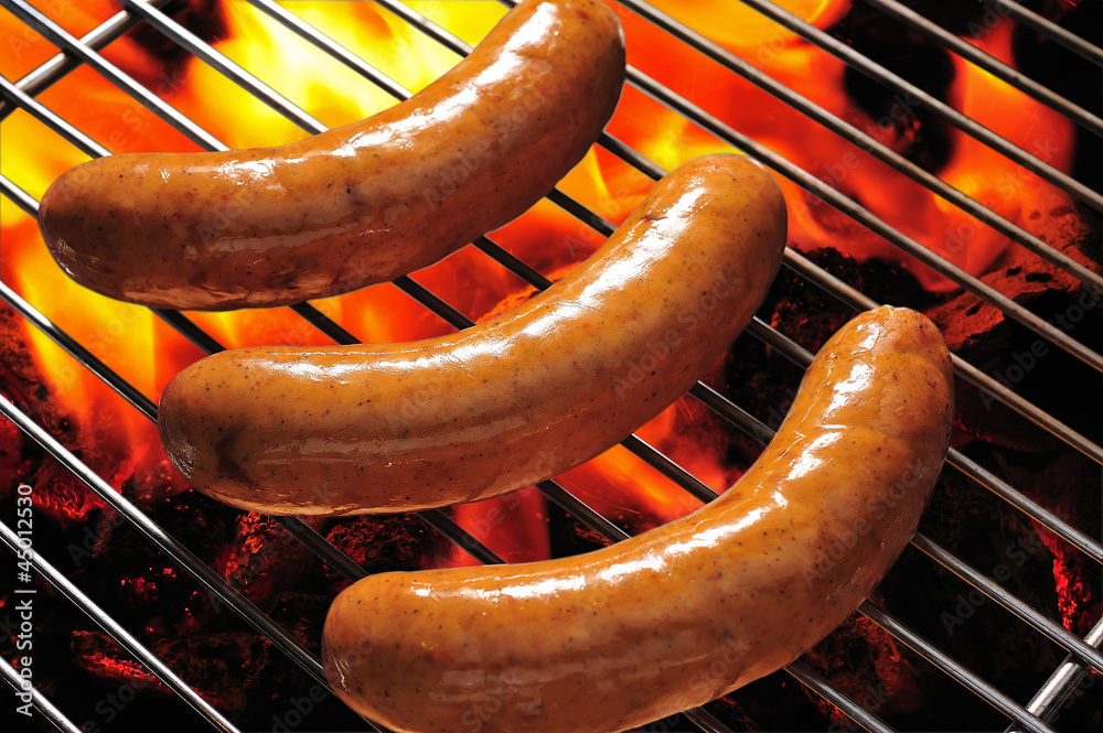 grilled sausages on the flaming grill