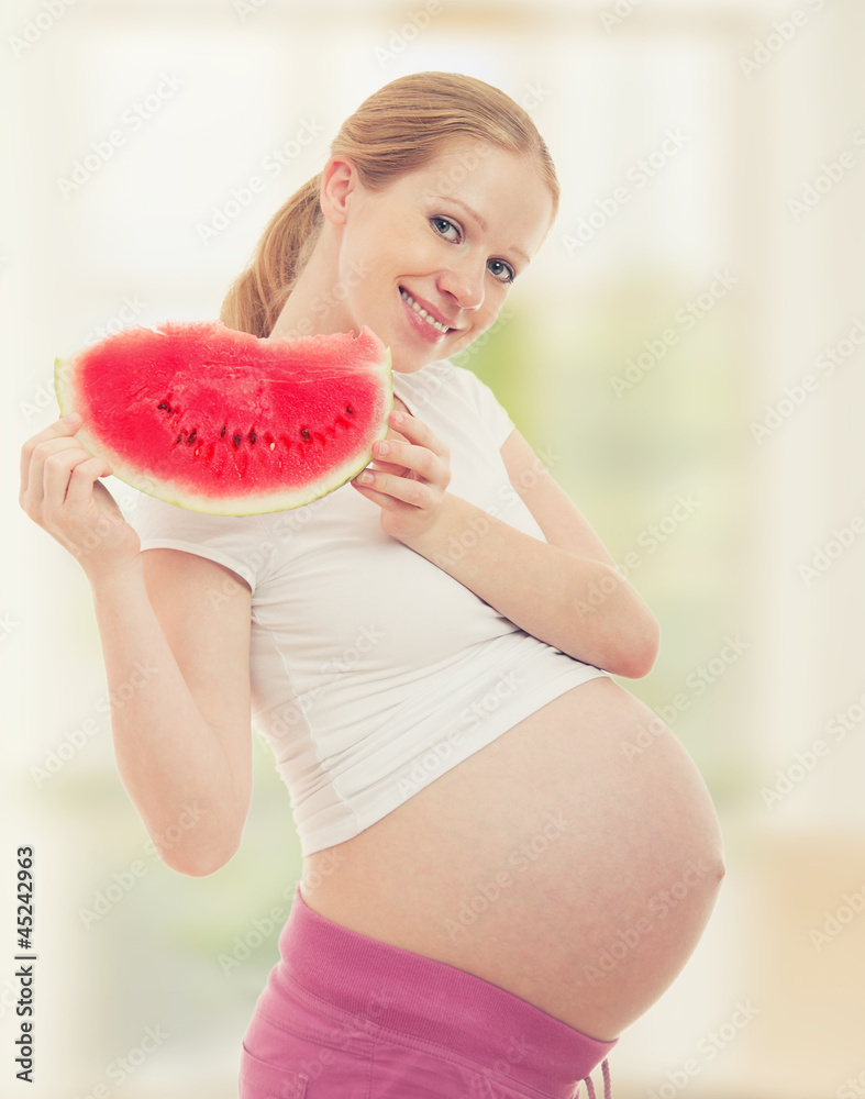 Pregnancy and healthy food. pregnant woman watermelon