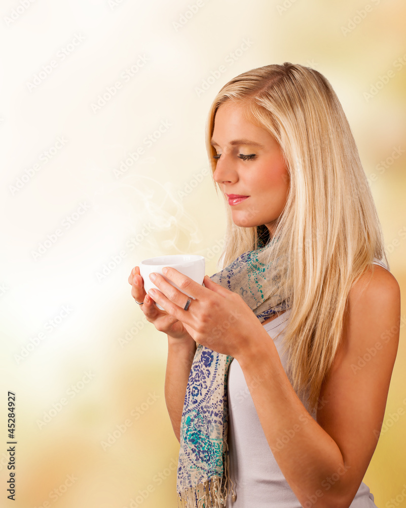 Autumn portrait of beautiful blond woman drinking tea