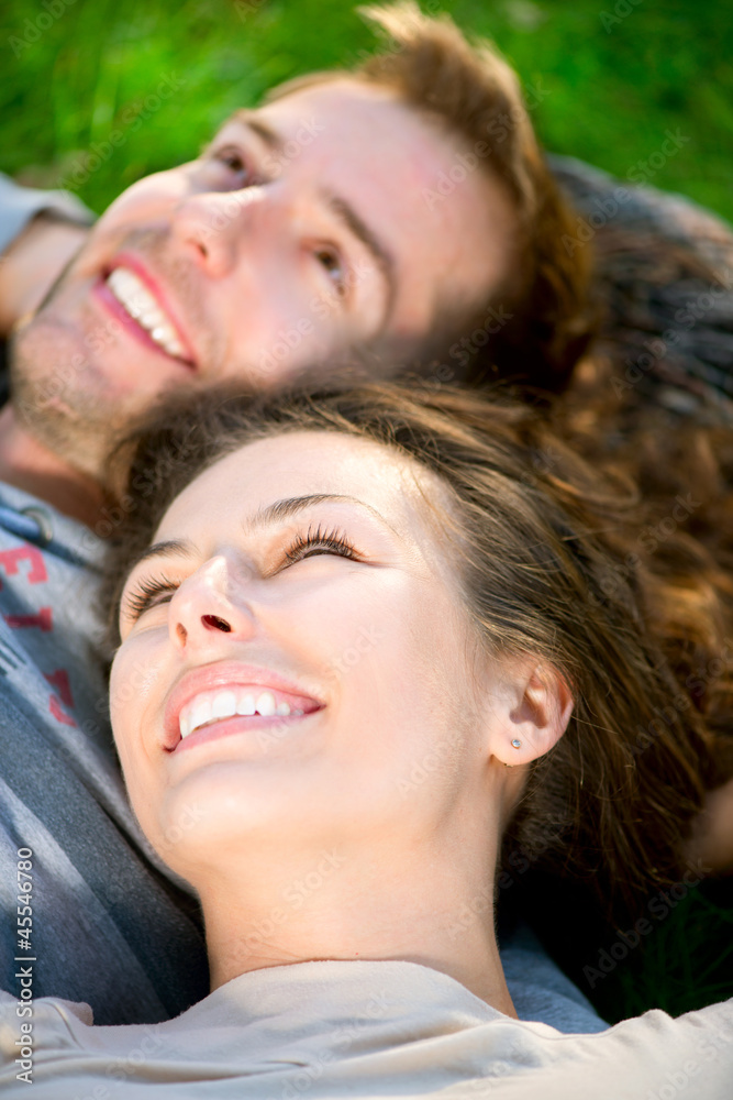 Young Couple Lying on Grass Outdoor