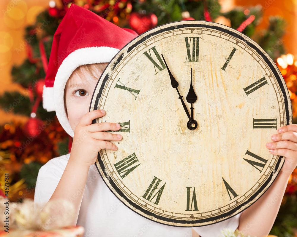 Kid hiding by old wooden clock