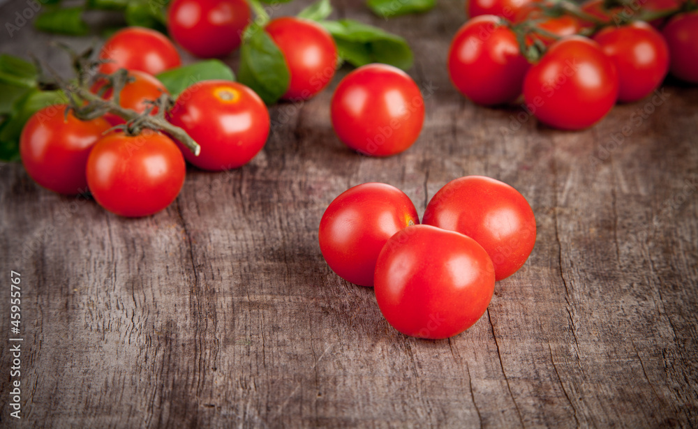 Cherry tomatoes on wooden table, low depth of focus