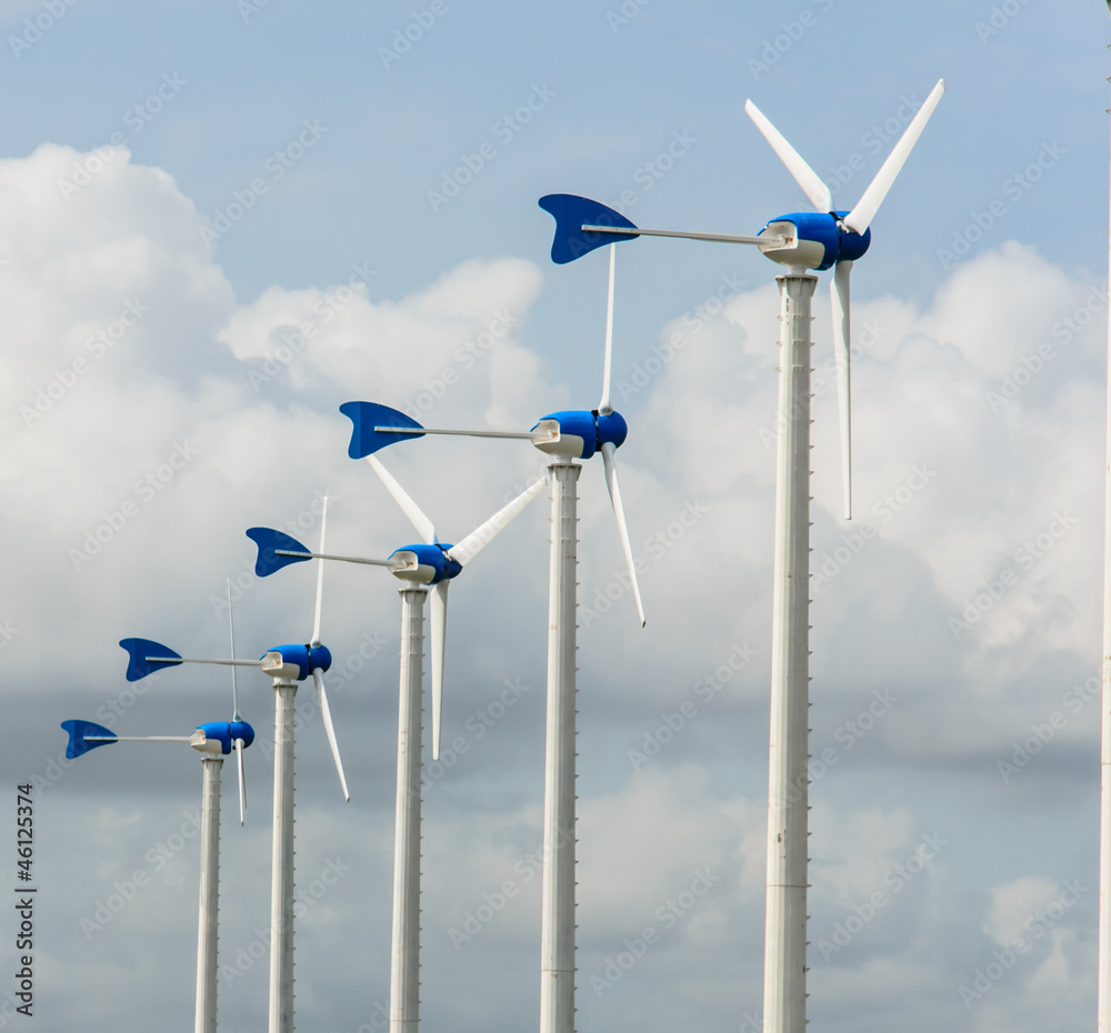 white wind turbine on blue sky