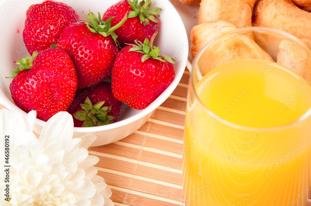 Breakfast with berries,orange juice and croissant