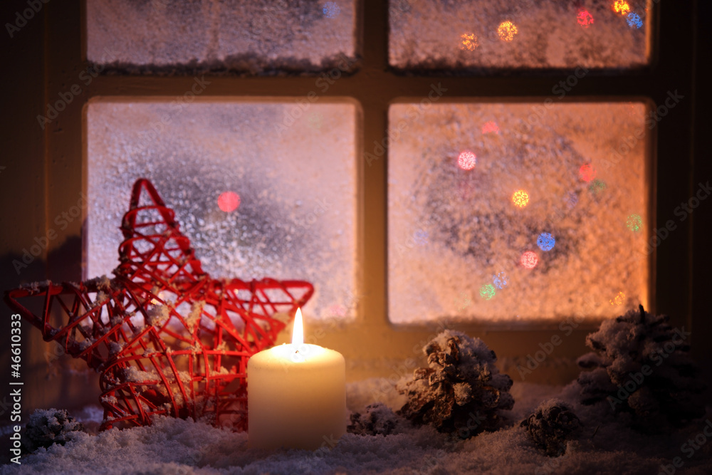 Frosted window with festive candles