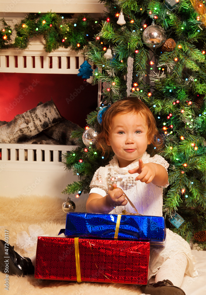 Little girl sitting with presents