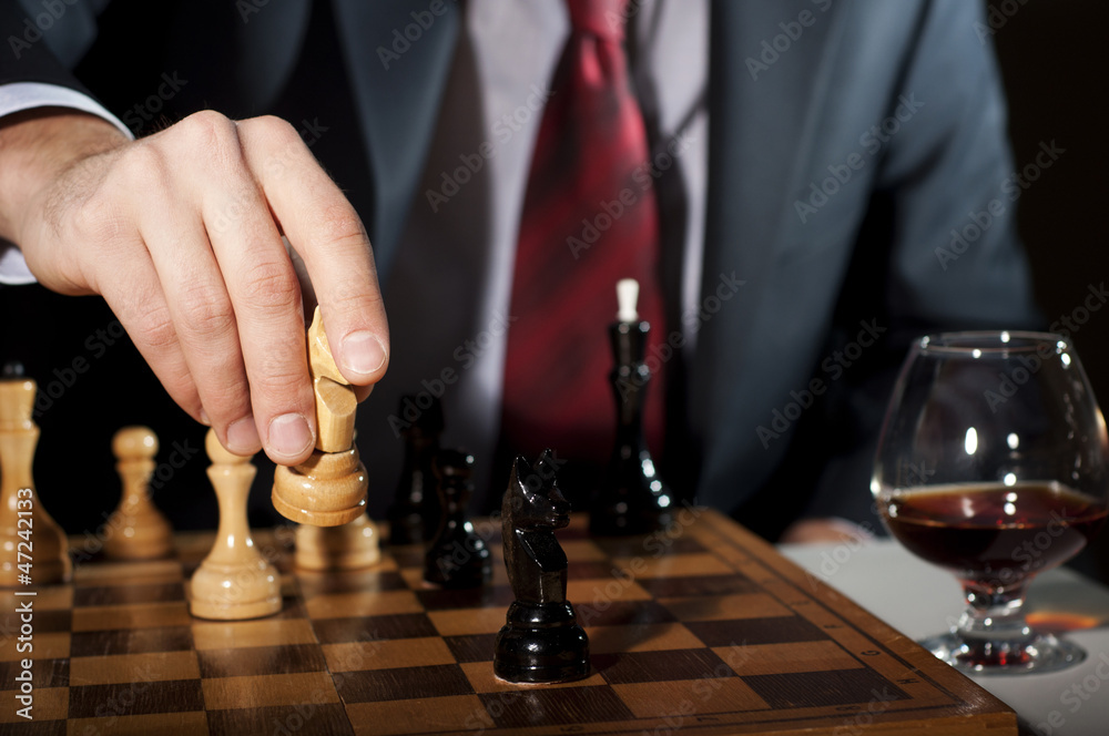 businessman plays chess