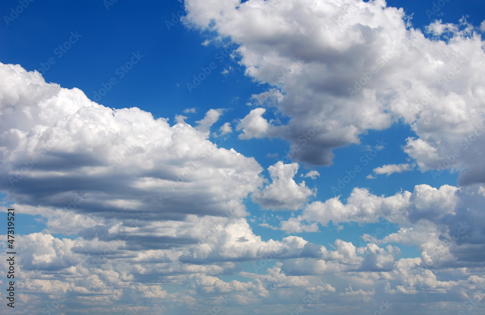 Blue sky with many cumulus white clouds.