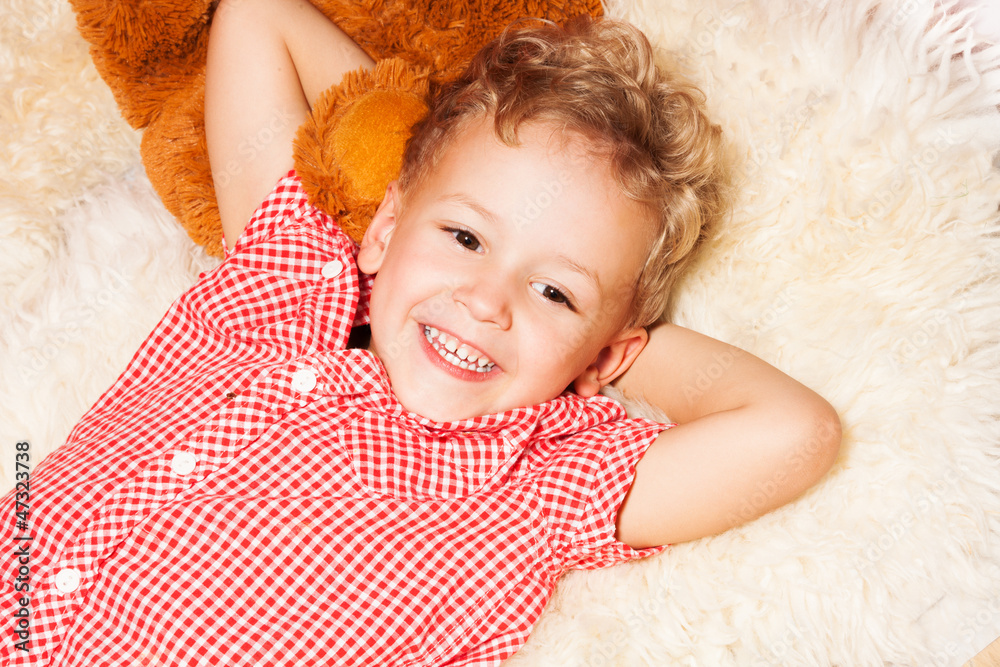 Happy blond kid  on the furs