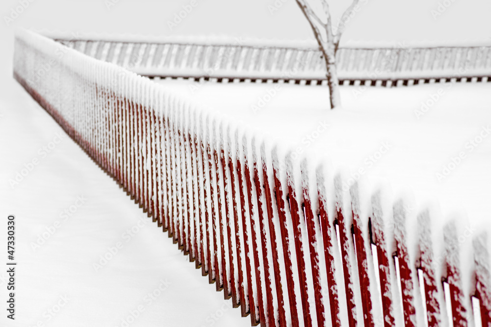 Red fence in winter